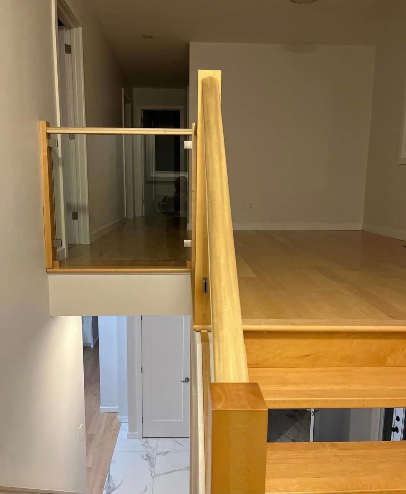 Staircase with glass-panel railing