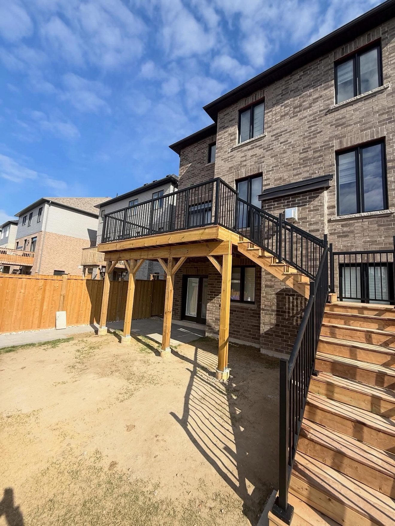 Two-storey deck with black railings